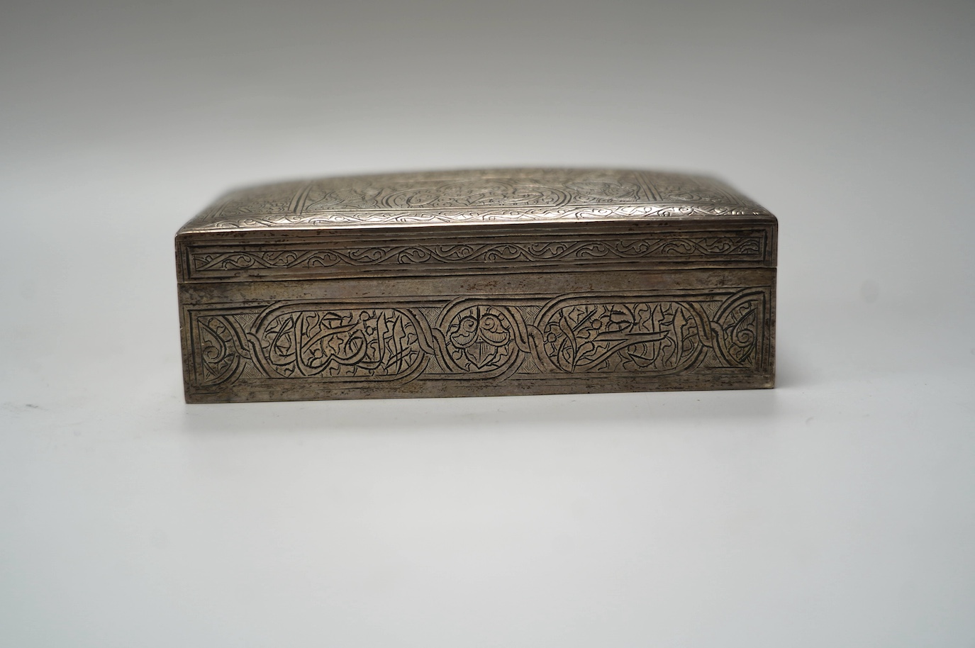 A Middle Eastern engraved white metal rectangular cigarette box, 12.5cm. Condition - fair